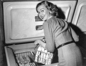 A young homemaker shows off her new deep-freeze, circa 1952.  /// fashion, kitchens, appliances, homes ///